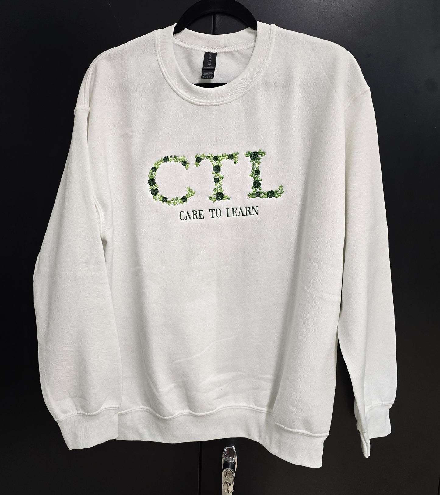 Sweatshirt: Care to Learn White Floral Emboridery